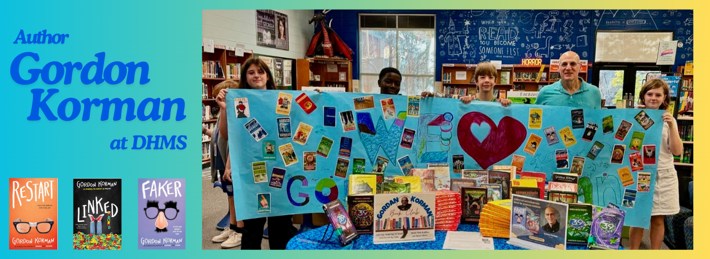 Author Gordon Korman at DHMS with photo of author and students